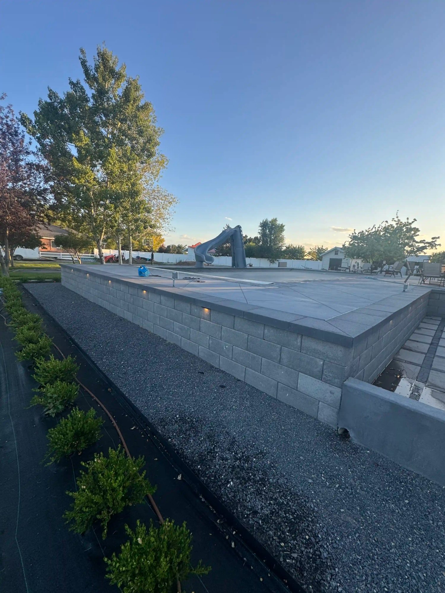 CMU retaining wall with pool deck by EC Landscaping Northern Utah