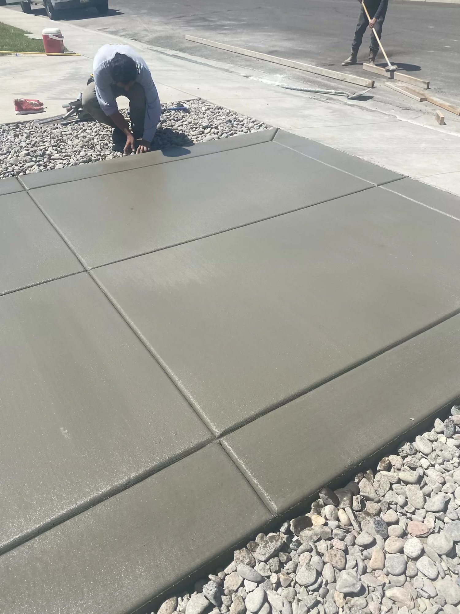Crew finishing concrete driveway edges