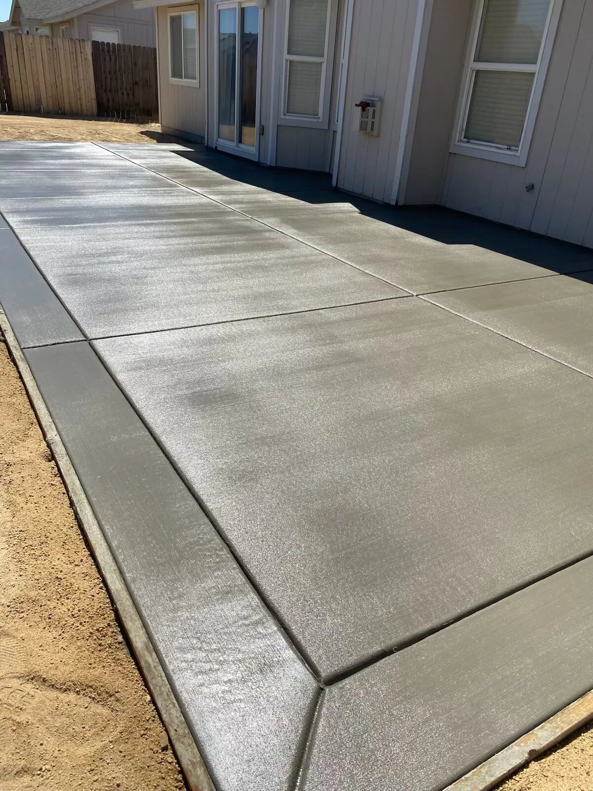 Fresh backyard concrete patio pour