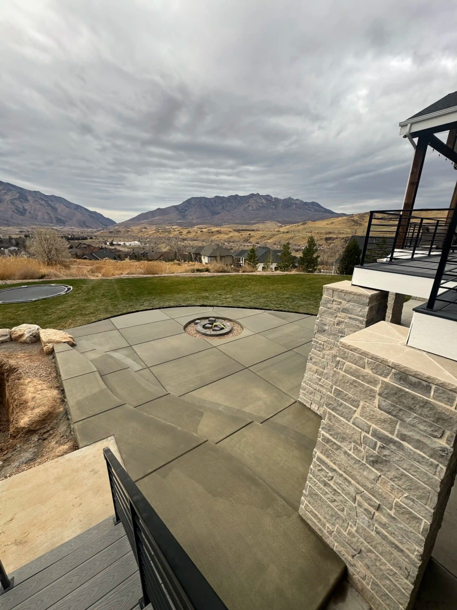 Finished concrete patio fire pit mountain view Utah
