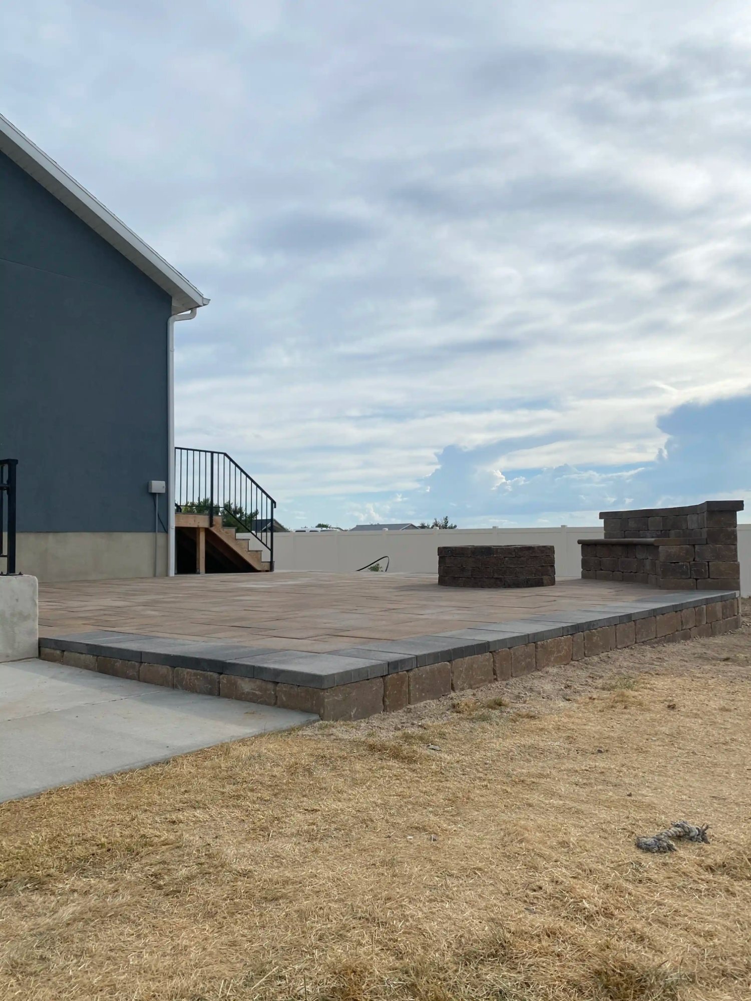 Raised paver patio with pillars